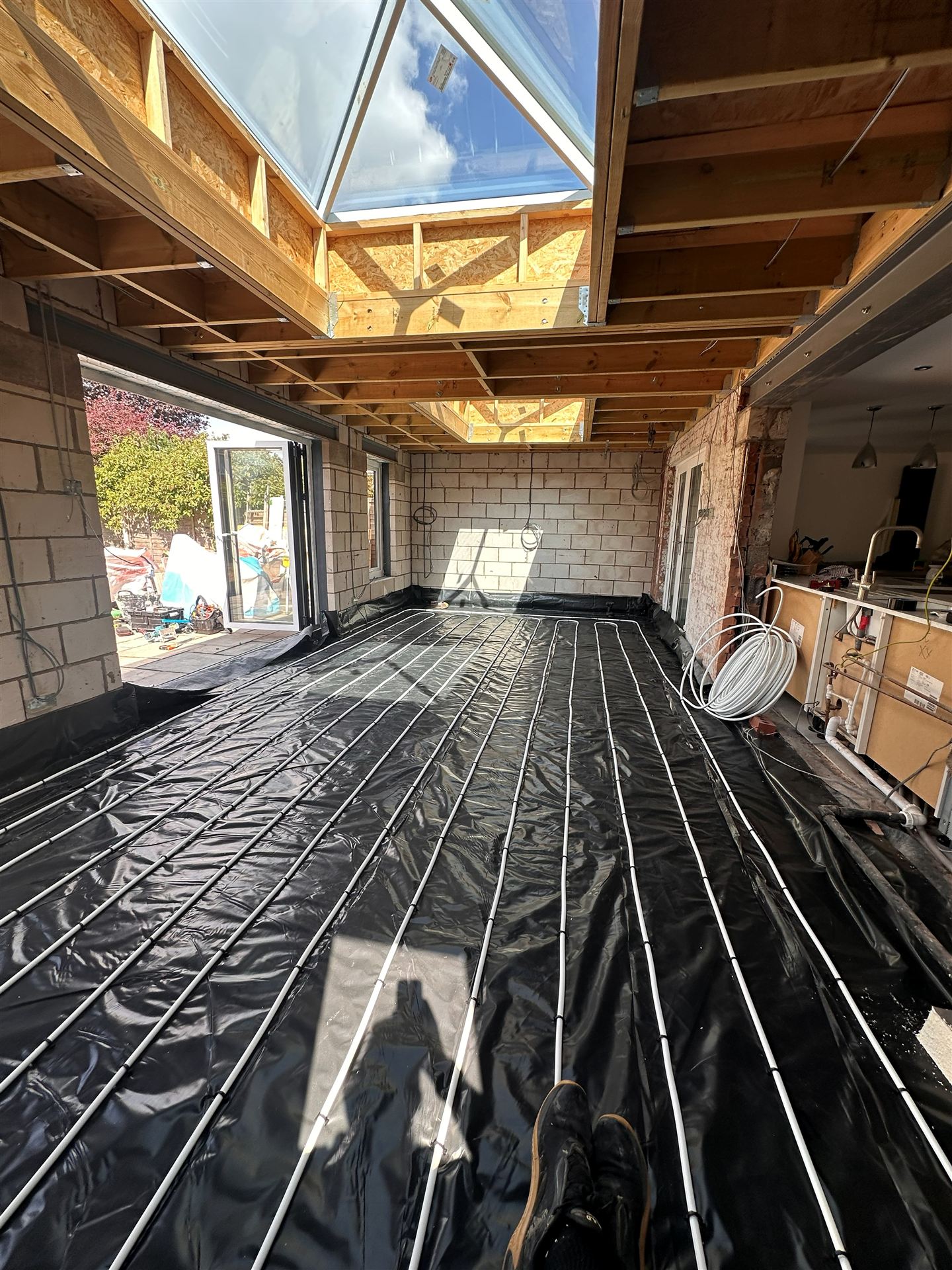 Underfloor heating pipework being laid in a new extension