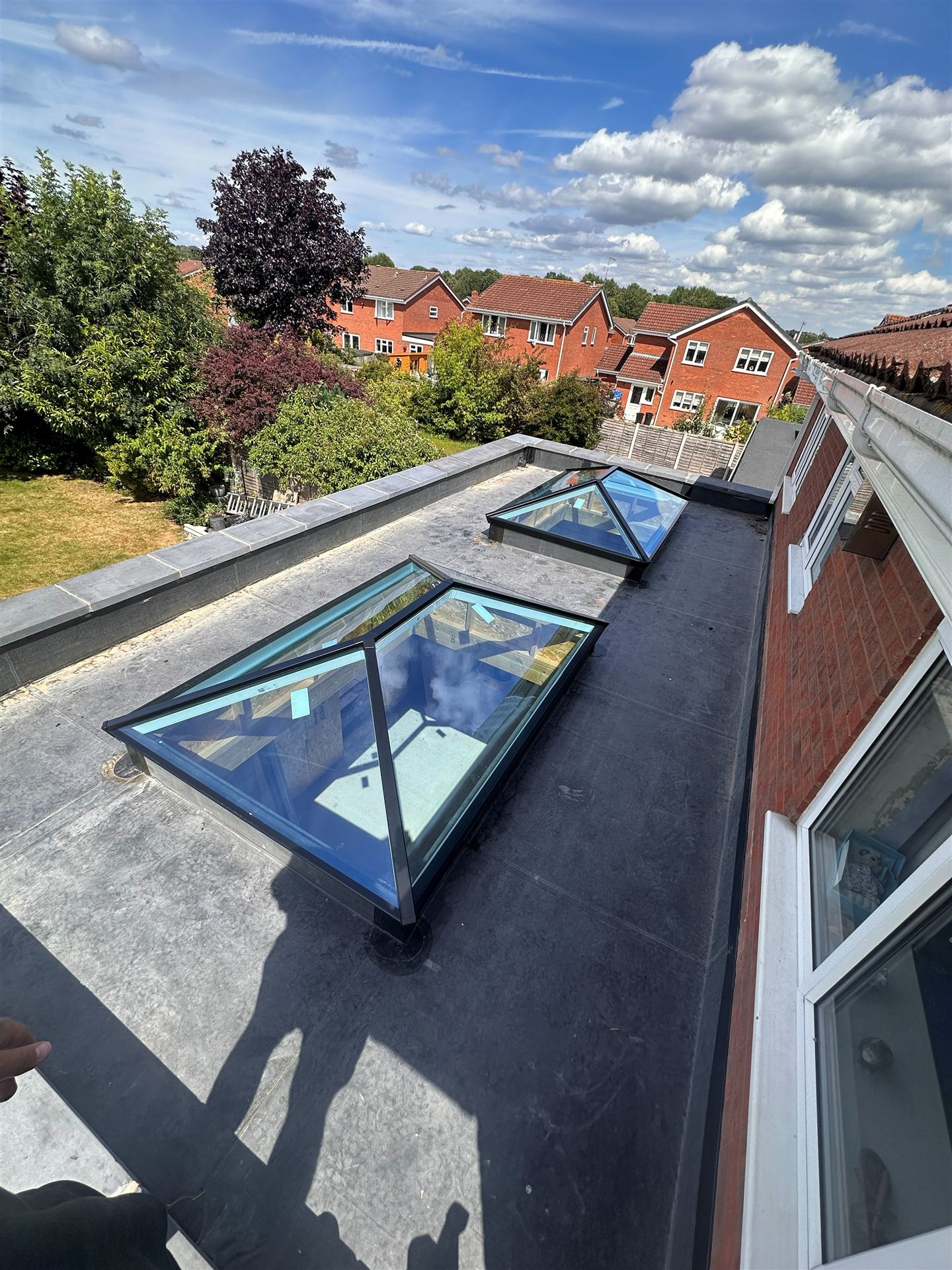 Twin glass roof lanterns fitted on a flat-roof extension