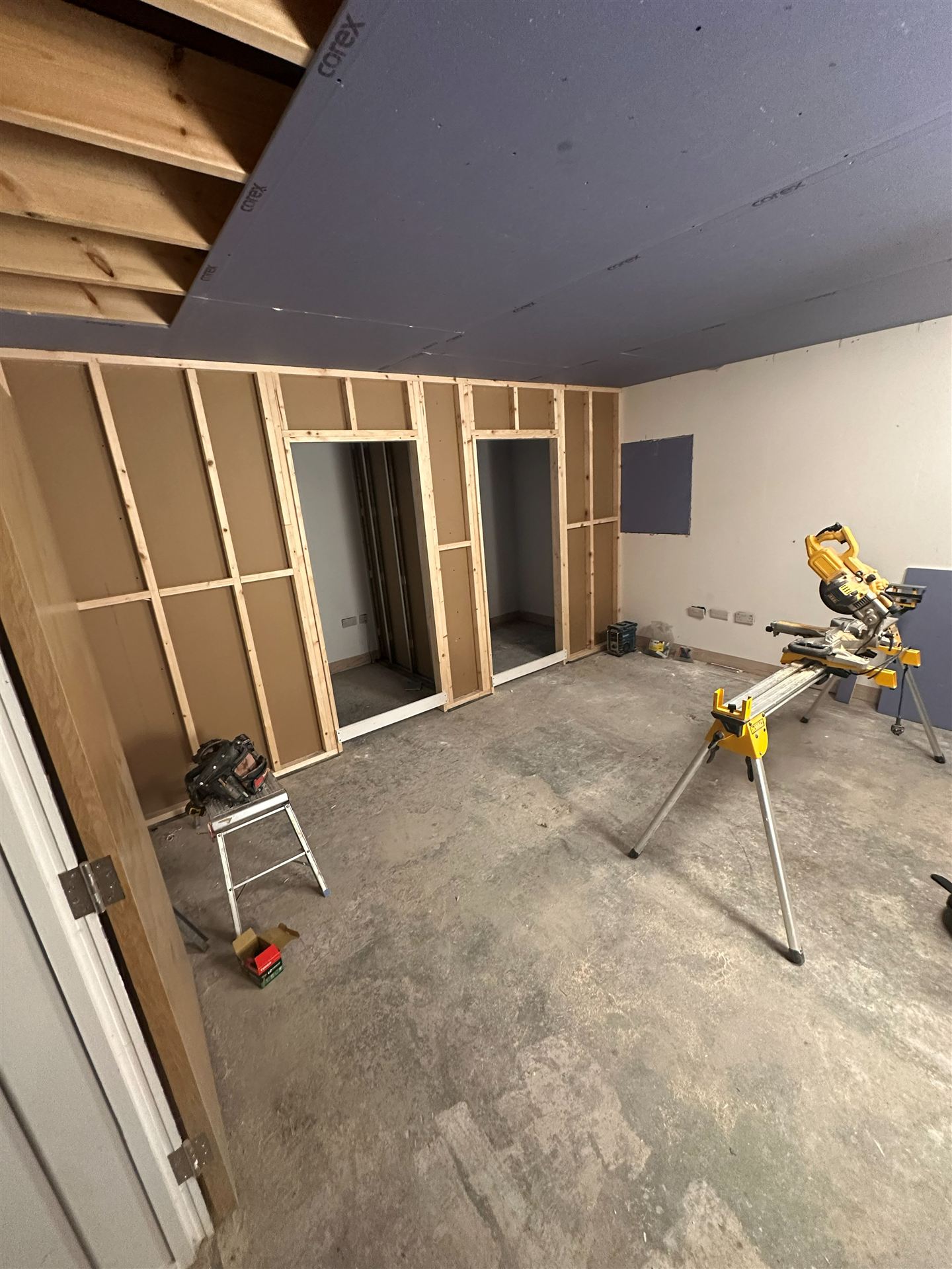 Stud wall framing with door openings and mitre saw station
