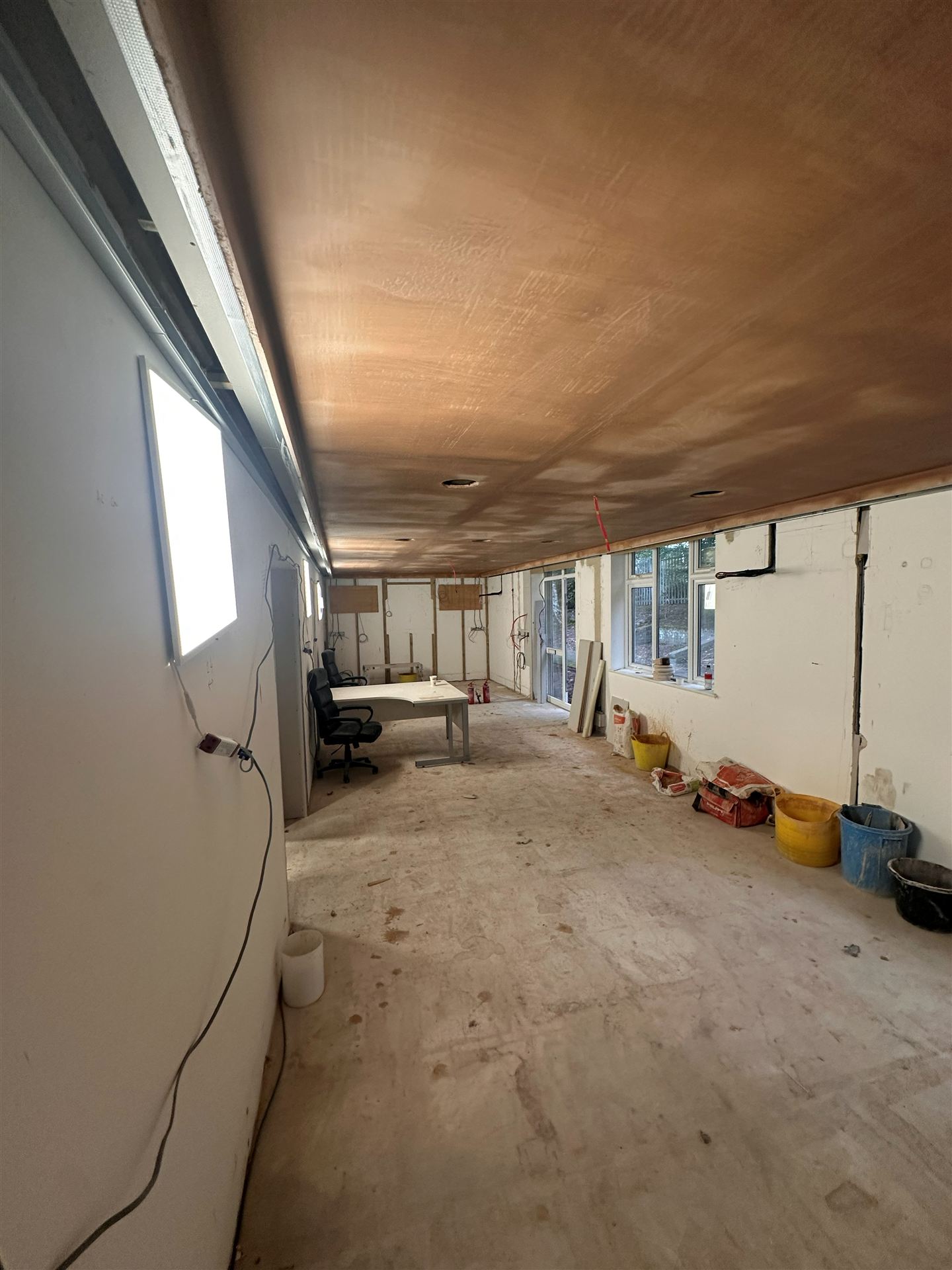 Plastered office space with desk
