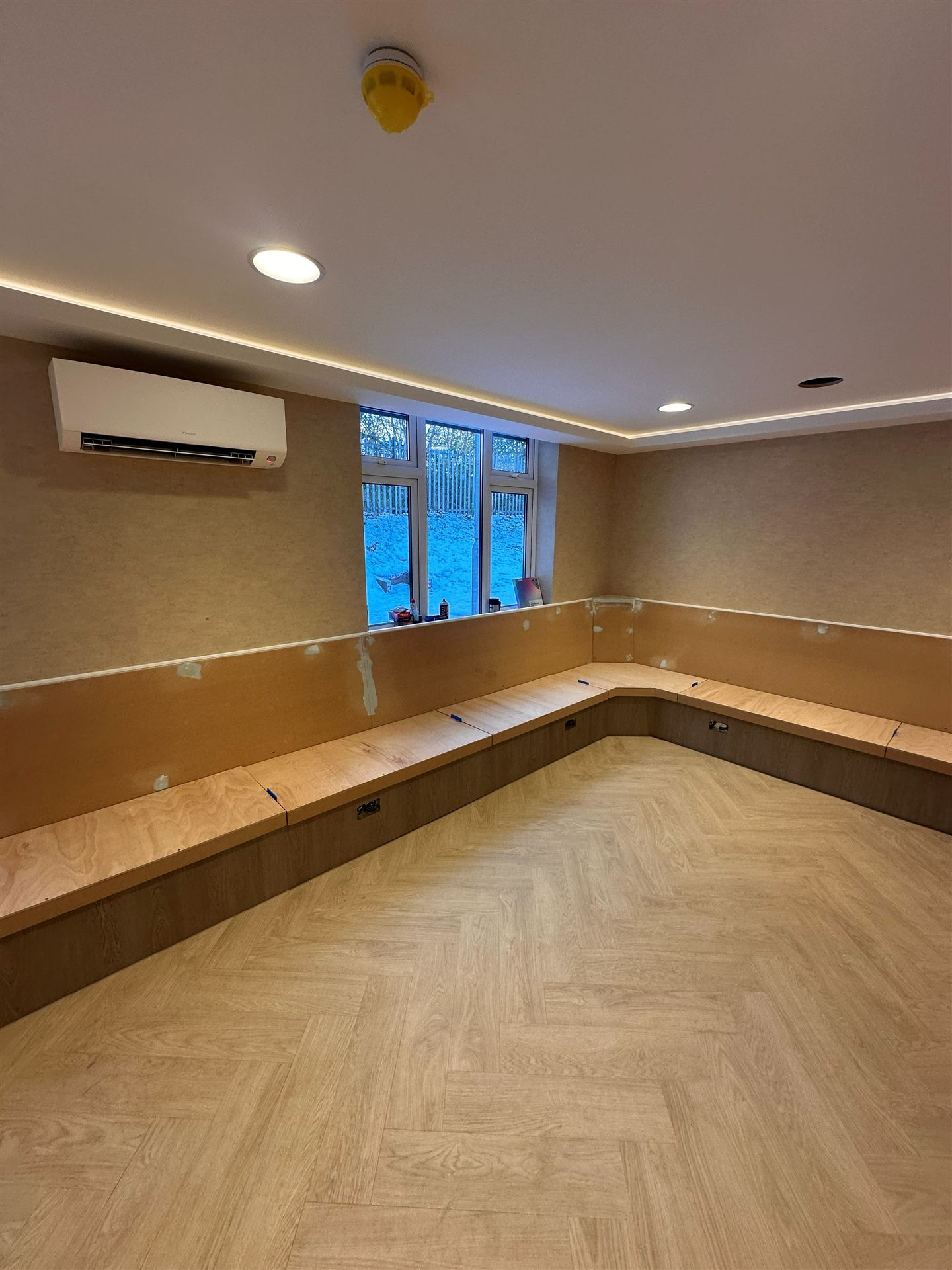 Finished bench seating area with air conditioning unit